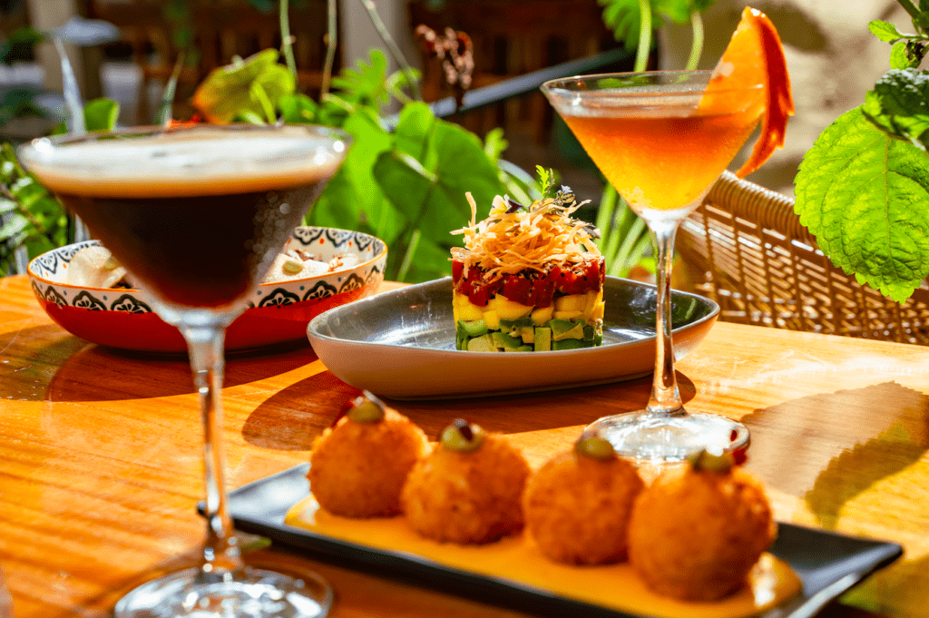 Cocktails and croquettes on a wooden table at Medusa restaurant