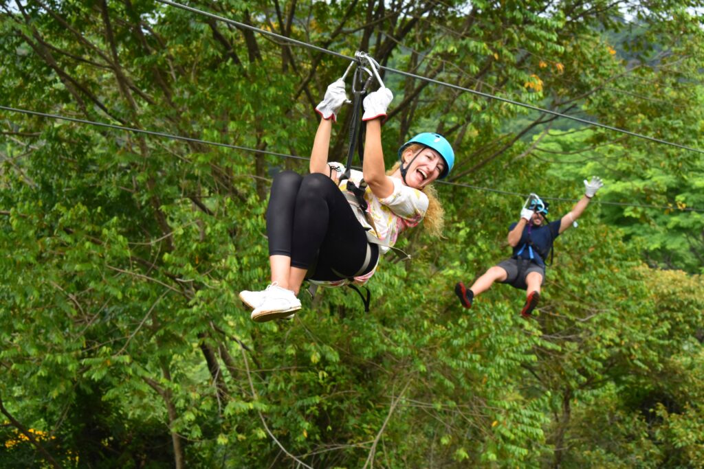 Guest smiling on the zip line at El Santuario Canopy