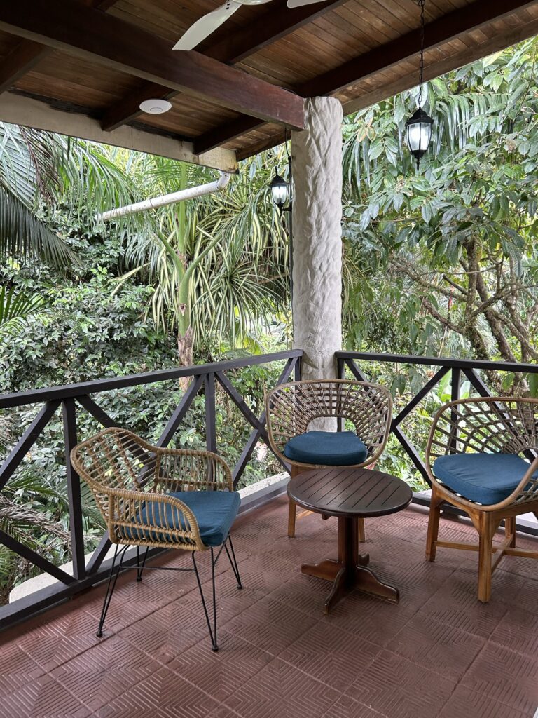 Rattan chairs on a terrace overlooking the jungle